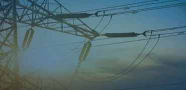 Power line with hazy sky and sun in the background