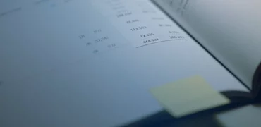 Page open to numbers with a yellow post it on page